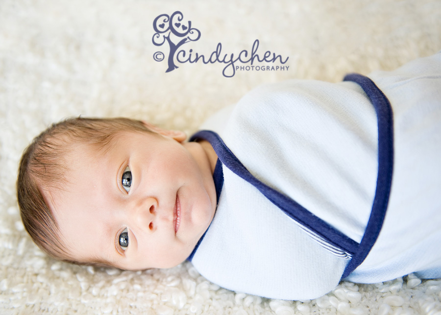 awake newborn baby boy with beautiful blue eyes